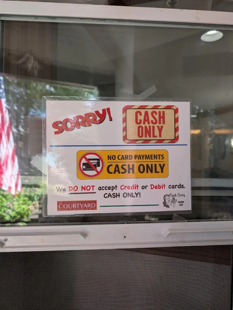 Cash only sign on the front door of The Courtyard Restaurant — no card payments accepted.