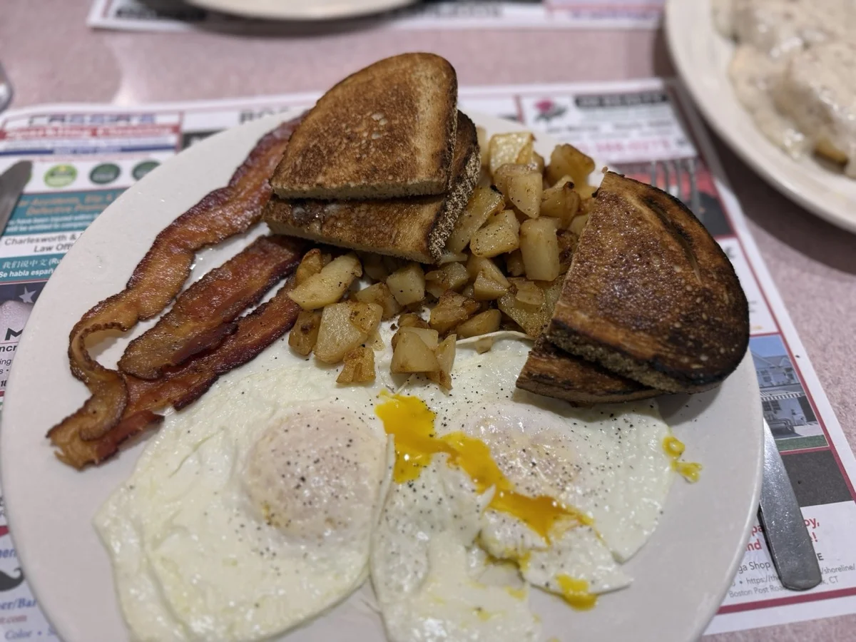 Two eggs, bacon, home fries, and toast.
