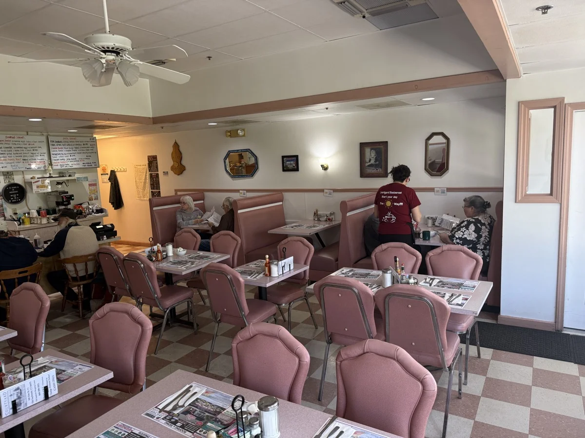 Server greeting regulars in the dining room.